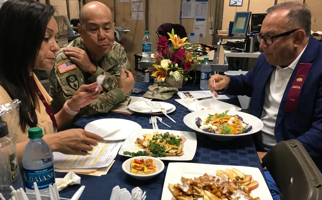 The judges evaluate the four-course meal creation by Purple Pig chef Aaron Anderson and California National Guard major Shannon Terry during the competition.