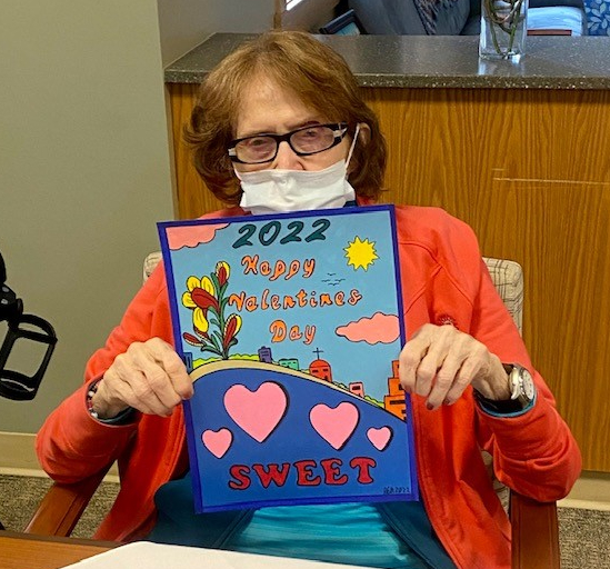 Sweet Happy Valentine's Day Card being held up for viewing by Home resident and veteran Dottie.