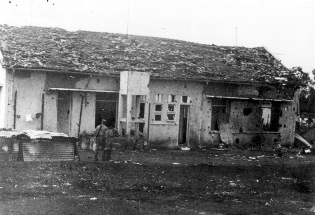 The rear view of a badly burnt out building  at Dong Xoai, June 1965.