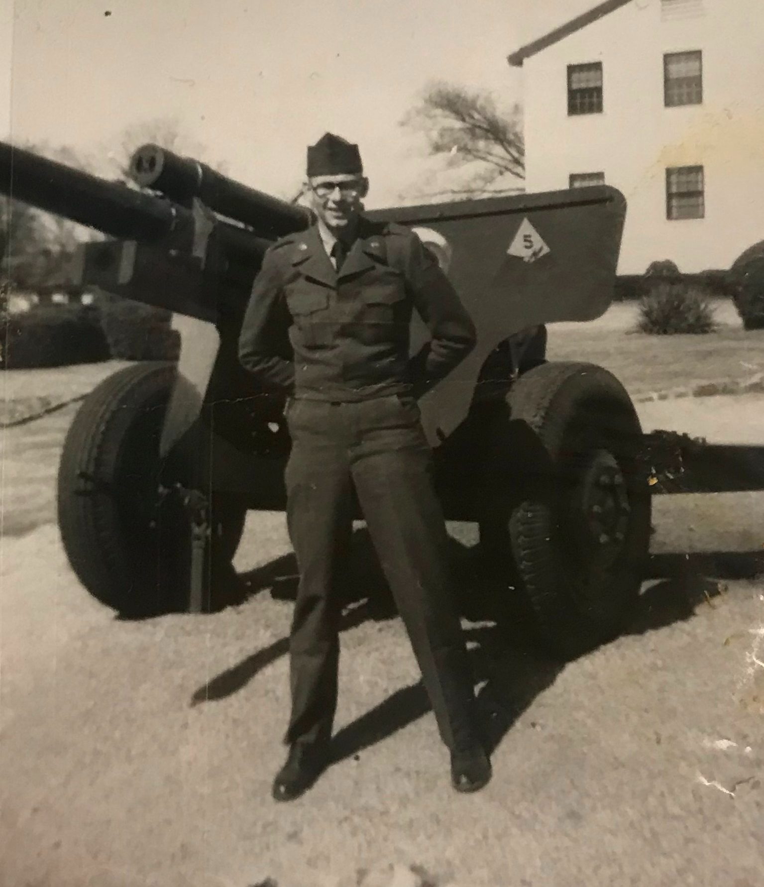 Bob Lewis in uniform standing in front of a cannon.
